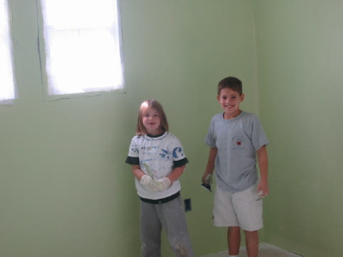 Charlotte and Blake pause from helping paint